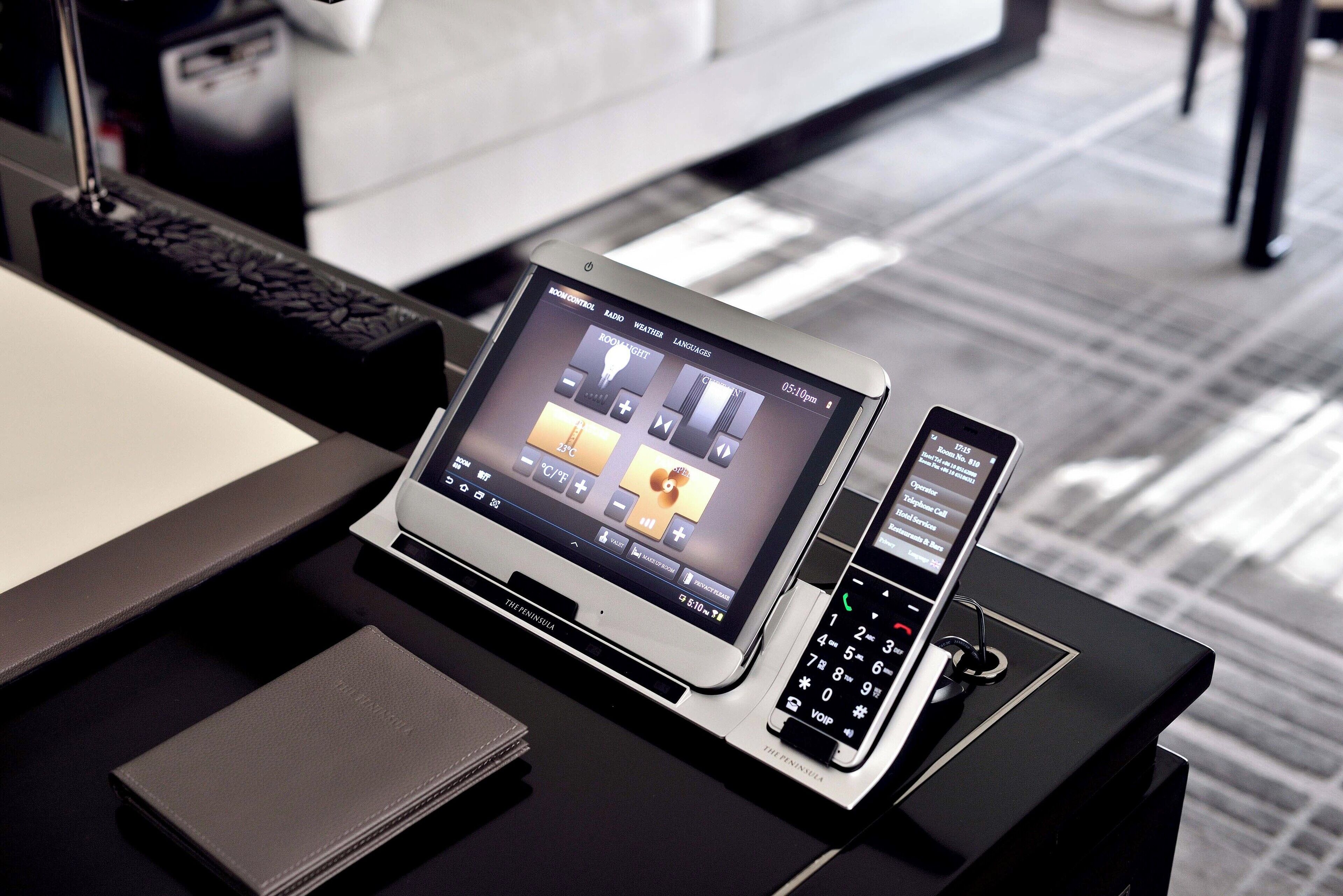 A desk with a laptop, a smartphone, and a wallet.