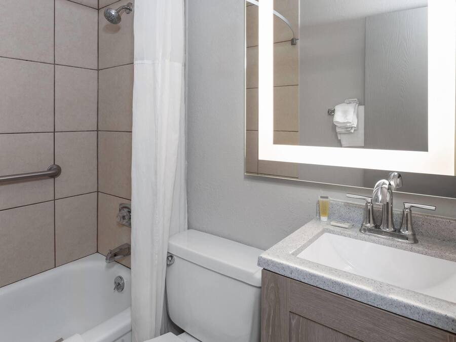 A modern bathroom with a bathtub, toilet, and sink.
