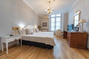 Relax in comfort with a large bed, desk, and TV.