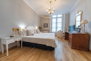Relax in comfort with a large bed, desk, and TV.