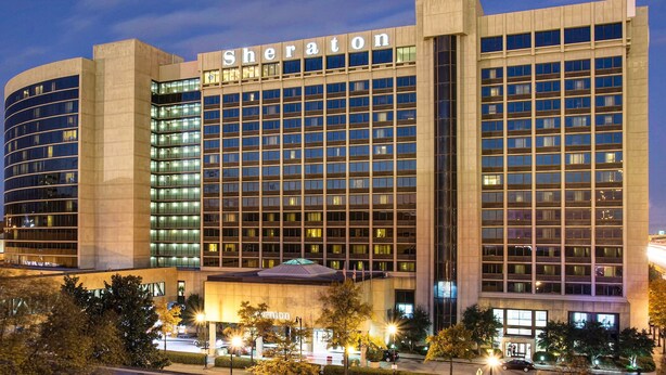 A Sheraton hotel with a modern design, featuring a prominent 'Sheraton' sign, multiple floors, and a well-lit facade. - Sheraton Birmingham Hotel (Birmingham)