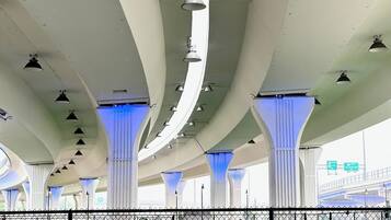 An architectural structure with multiple columns and hanging lights.