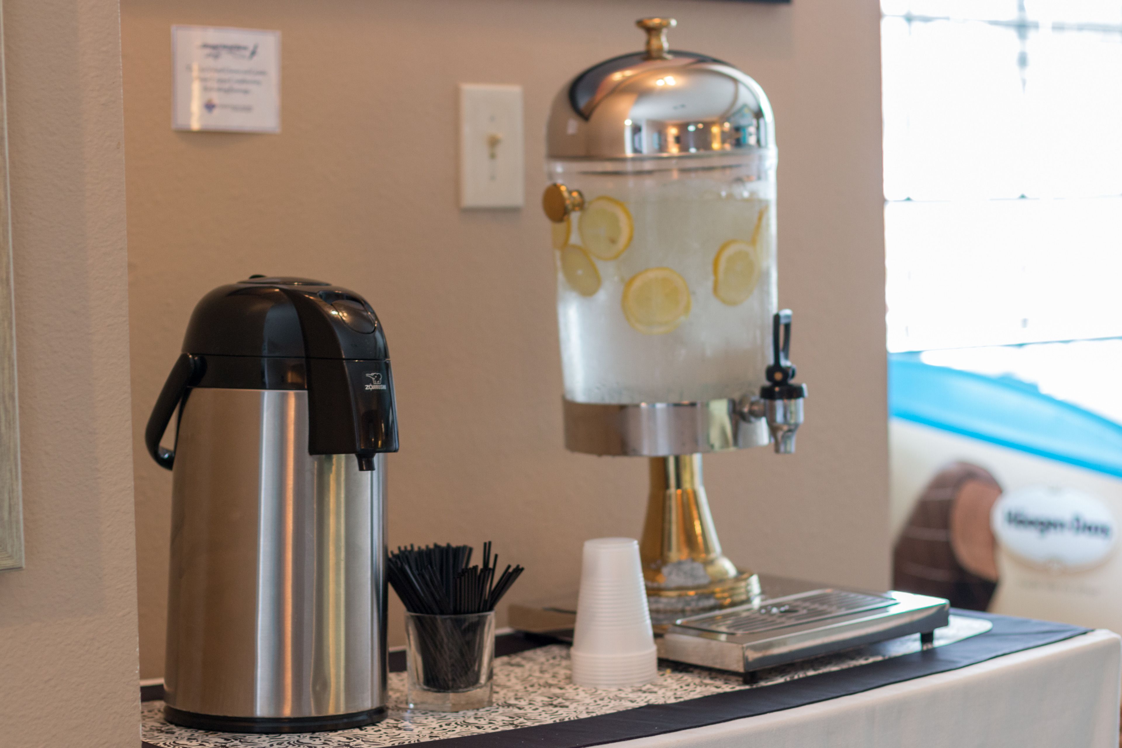 A coffee machine and a water dispenser on a counter.