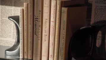 A bookshelf with several books, including titles like 'The Fiddler on the Roof' and 'American Icon'.