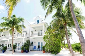 A two-story white building with balconies and potted plants. - Parrot Key Hotel & Villas (Key West)