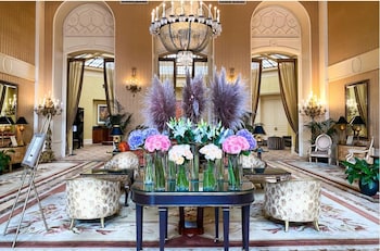 A lobby with a grand chandelier, a Christmas tree, and a revolving door. at InterContinental Mark Hopkins by IHG