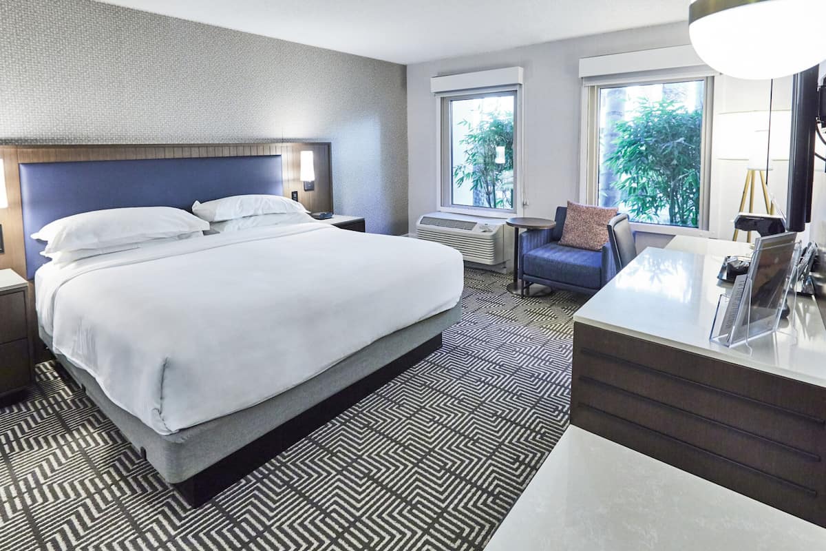 deluxe room, 1 king bed | premium bedding, in-room safe, desk, iron/ironing board