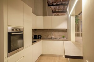 A modern kitchen with a built-in oven, a sink, and a countertop.
