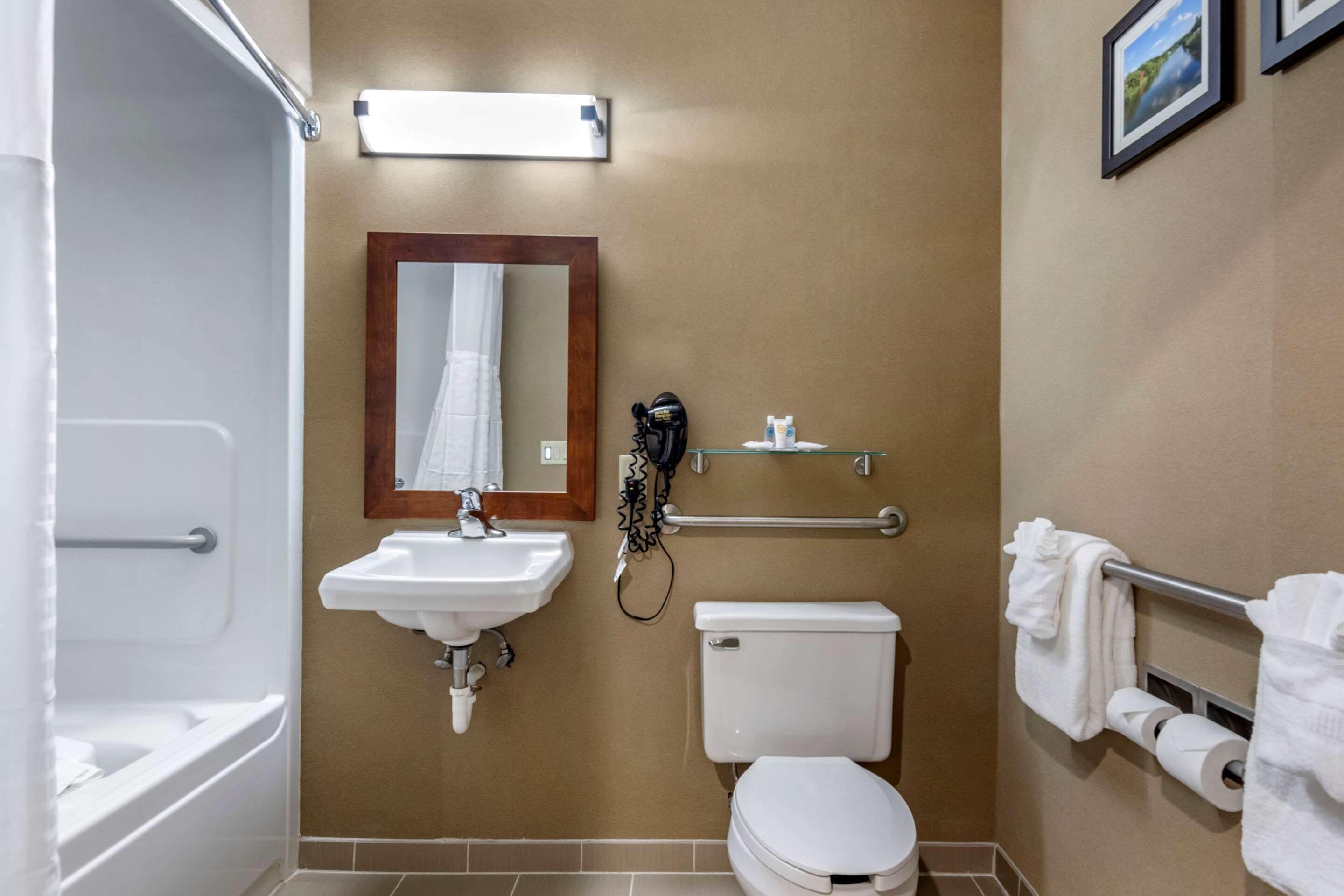A bathroom with a sink, toilet, and shower.