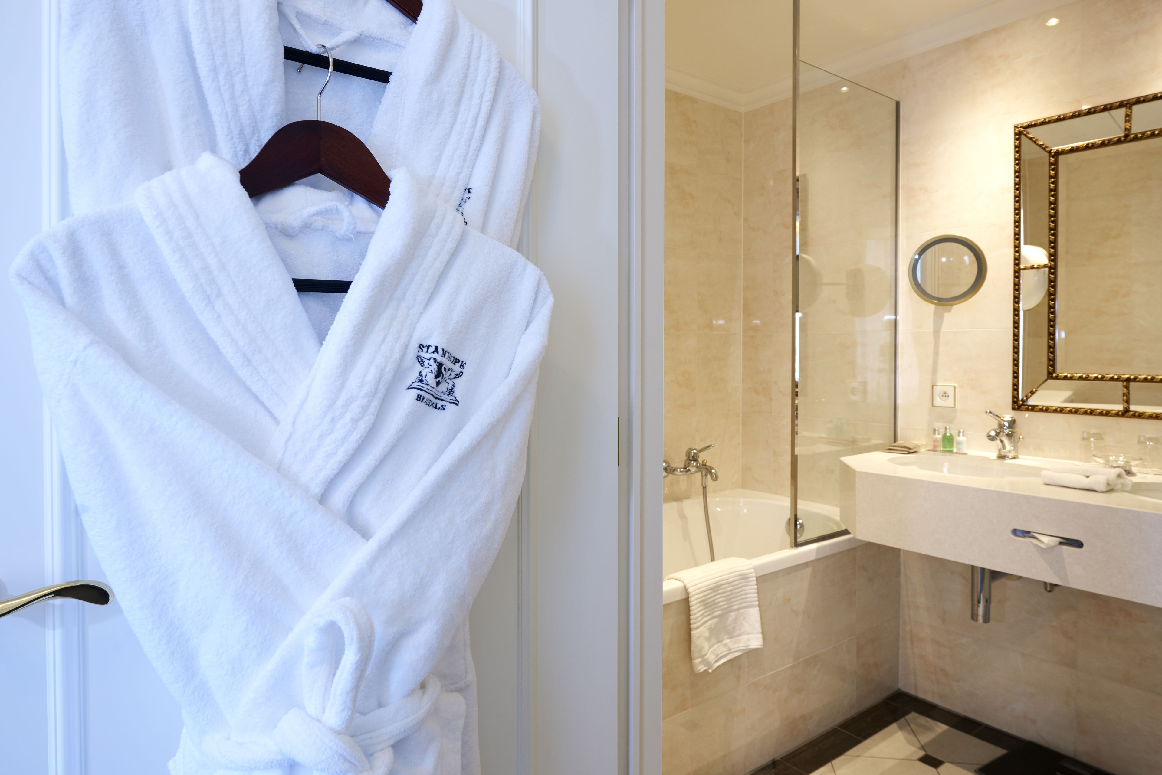 designer toiletries, hair dryer, bathrobes, slippers