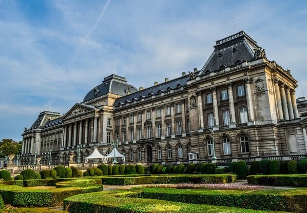 Ein großes, historisches Gebäude mit symmetrischer Architektur, das eine zentrale Kuppel und mehrere Säulen aufweist.