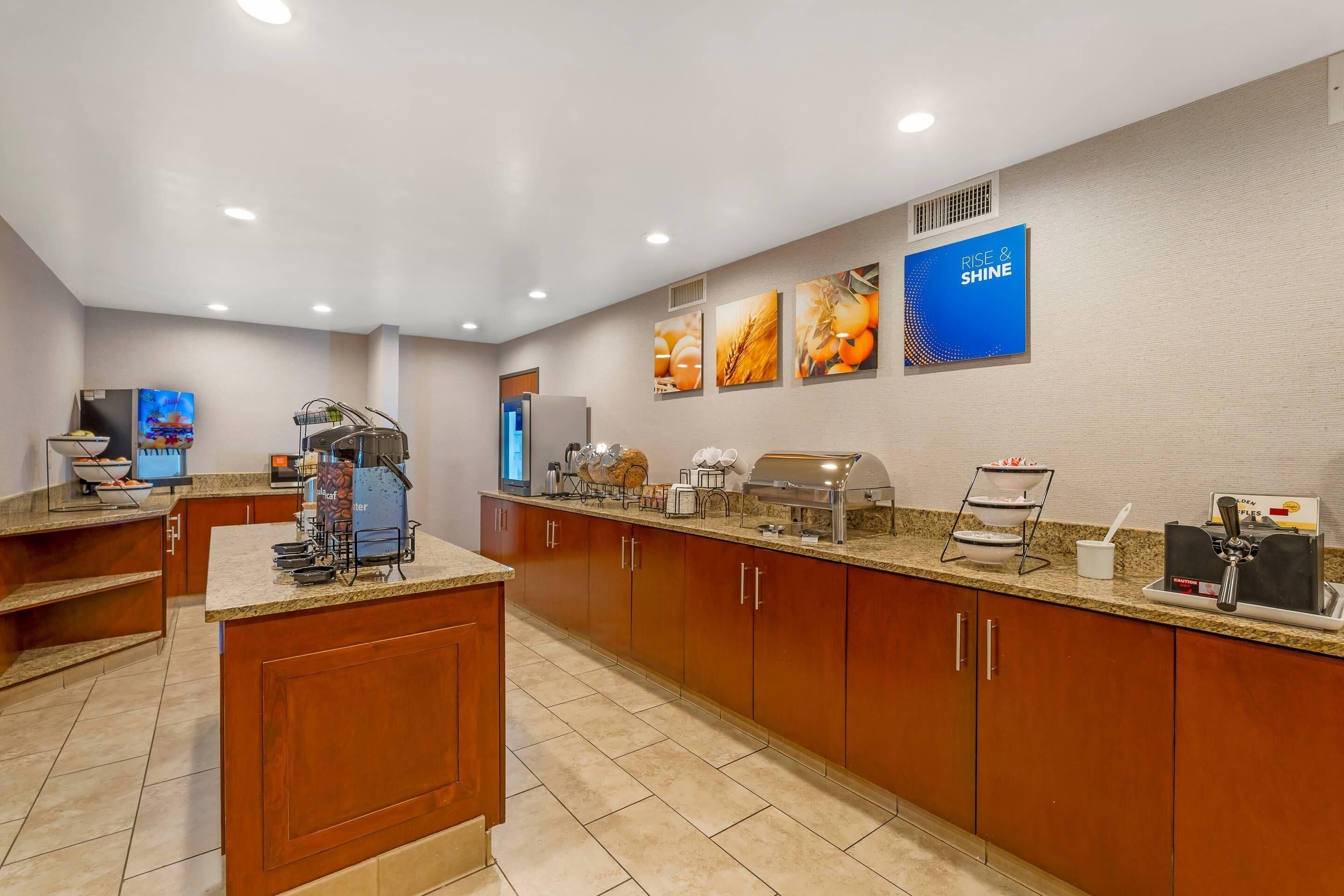 A modern kitchen with a coffee station, a buffet area, and a large island.
