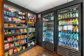 A vending area with snacks and drinks, including a water dispenser and a snack machine. - Comfort Inn Anaheim Resort (Anaheim)