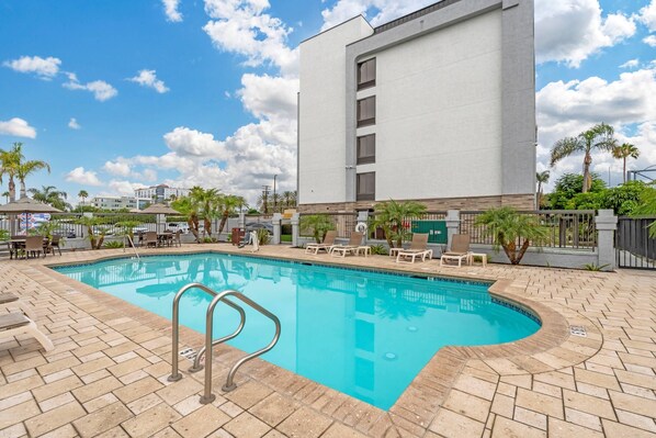 Alberca al aire libre, sombrillas en la alberca y camastros 