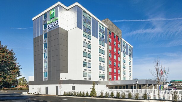 A Holiday Inn Express hotel with a modern design, featuring a prominent red accent on the facade. - Holiday Inn Express Richmond - Midtown by IHG (Richmond)