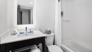 A modern bathroom with a white sink, mirror, and toilet. - Holiday Inn Express Richmond - Midtown by IHG (Richmond)