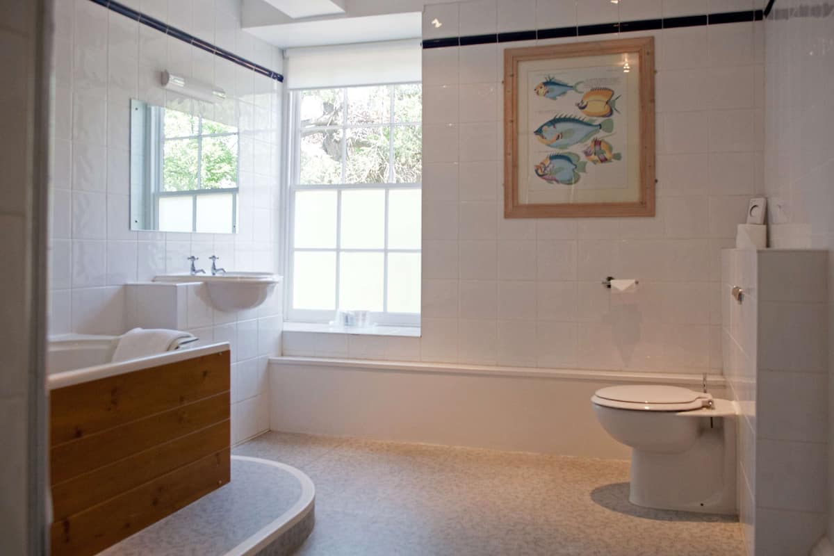 A bathroom with a bathtub, sink, and toilet.
