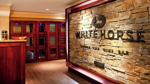 A stone wall with the sign "WHITEHORSE" and a wine rack behind it. - Sheraton Great Valley Hotel (Malvern)