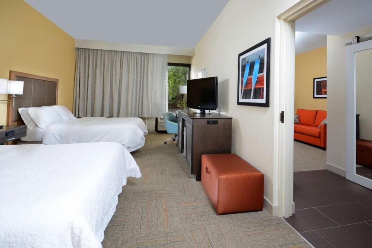 Premium bedding, desk, laptop workspace, blackout drapes