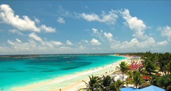 On the beach, white sand, sun-loungers, beach umbrellas