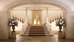 A grand staircase with a statue at the top, flanked by two large vases of flowers. - Valverde Sintra Palácio de Seteais - The Leading Hotels of the World (Sintra)