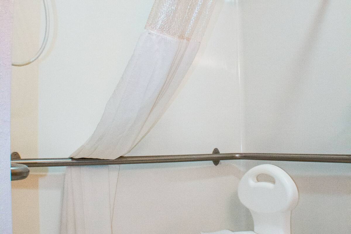 comfort single room, 1 king bed, accessible, non smoking (42 inch tv) | bathroom | combined shower/bathtub, rainfall showerhead, free toiletries