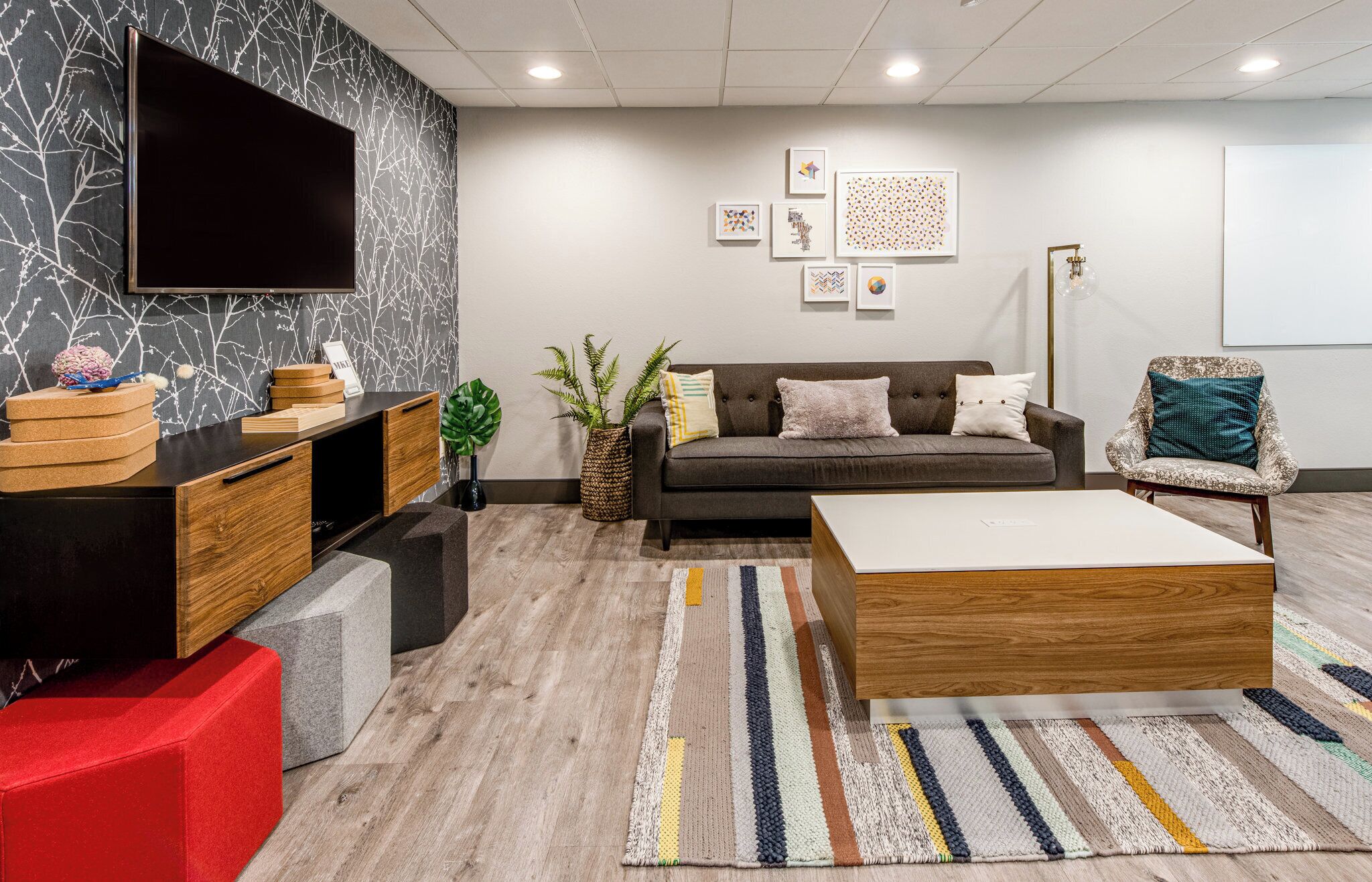 A modern living room with a sofa, coffee table, and entertainment unit.