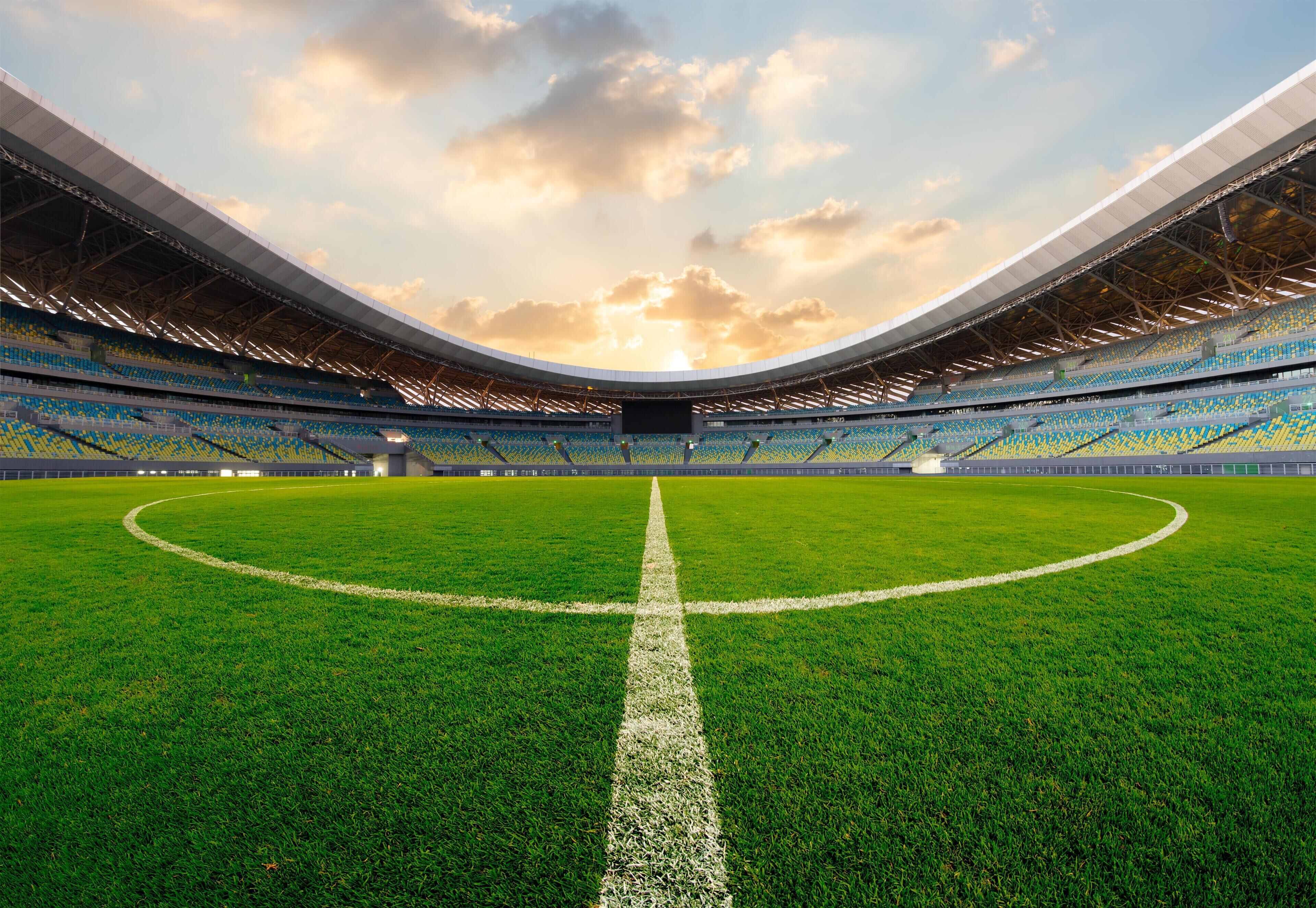 A stadium with a large, open field and tiered seating.