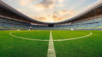 A stadium with a large, open field and tiered seating.