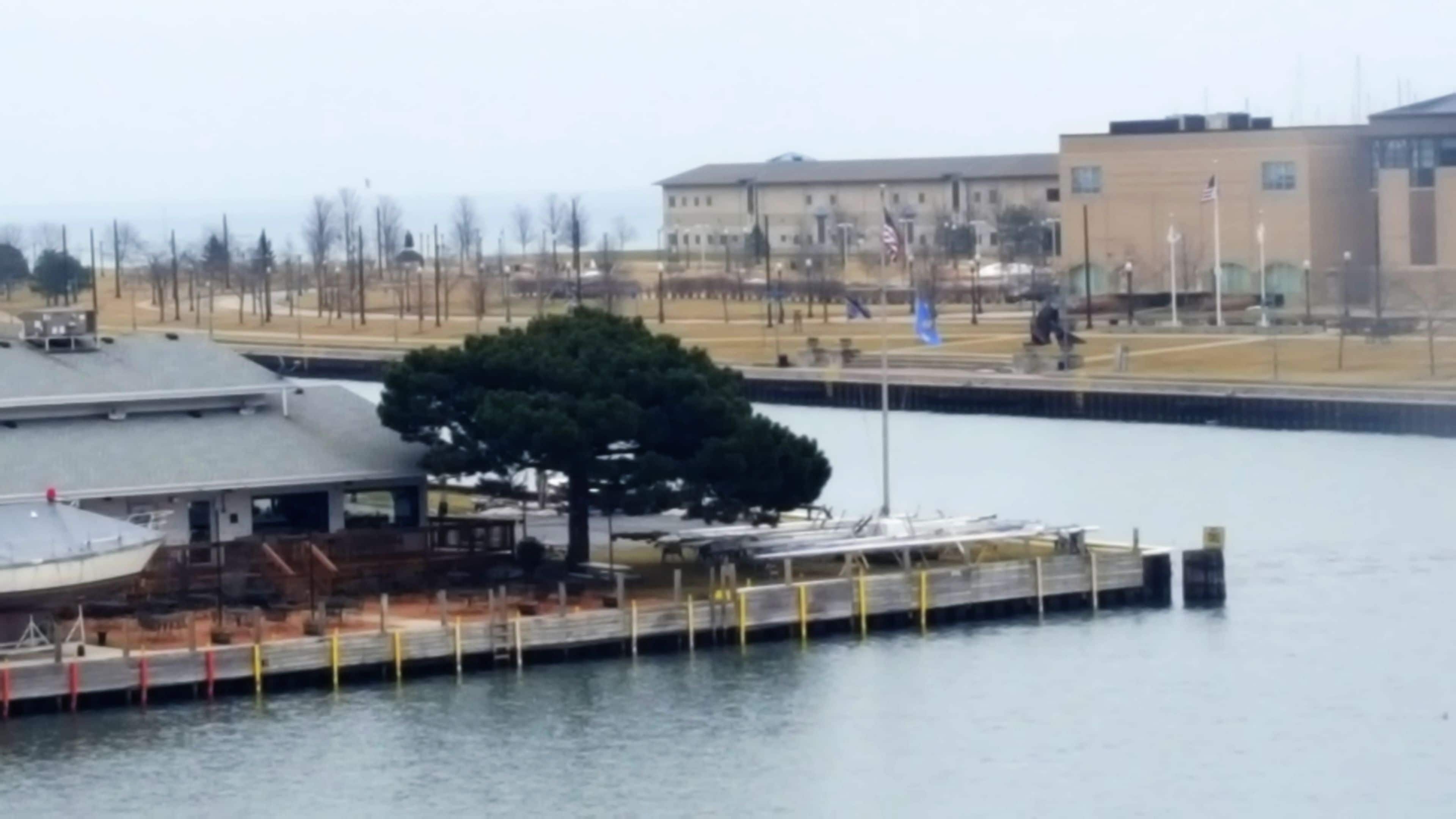 A waterfront dock with a building in the background.