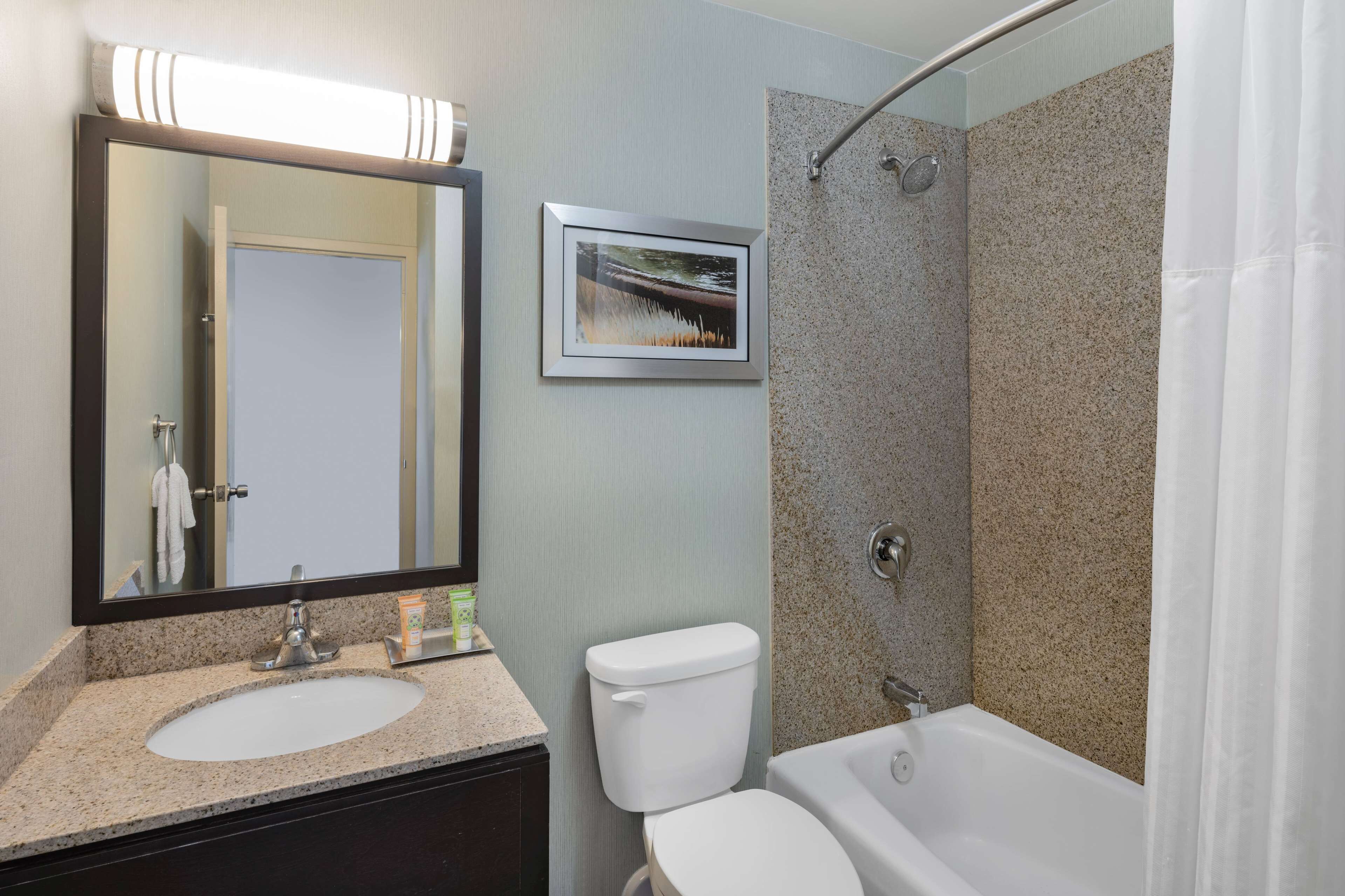 A bathroom with a sink, toilet, and bathtub.