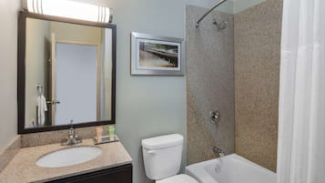 A bathroom with a sink, toilet, and bathtub.