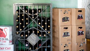 A wine selection board, a wine rack, and boxes of wine bottles. - Emerald Inn & Lounge (Blythe)