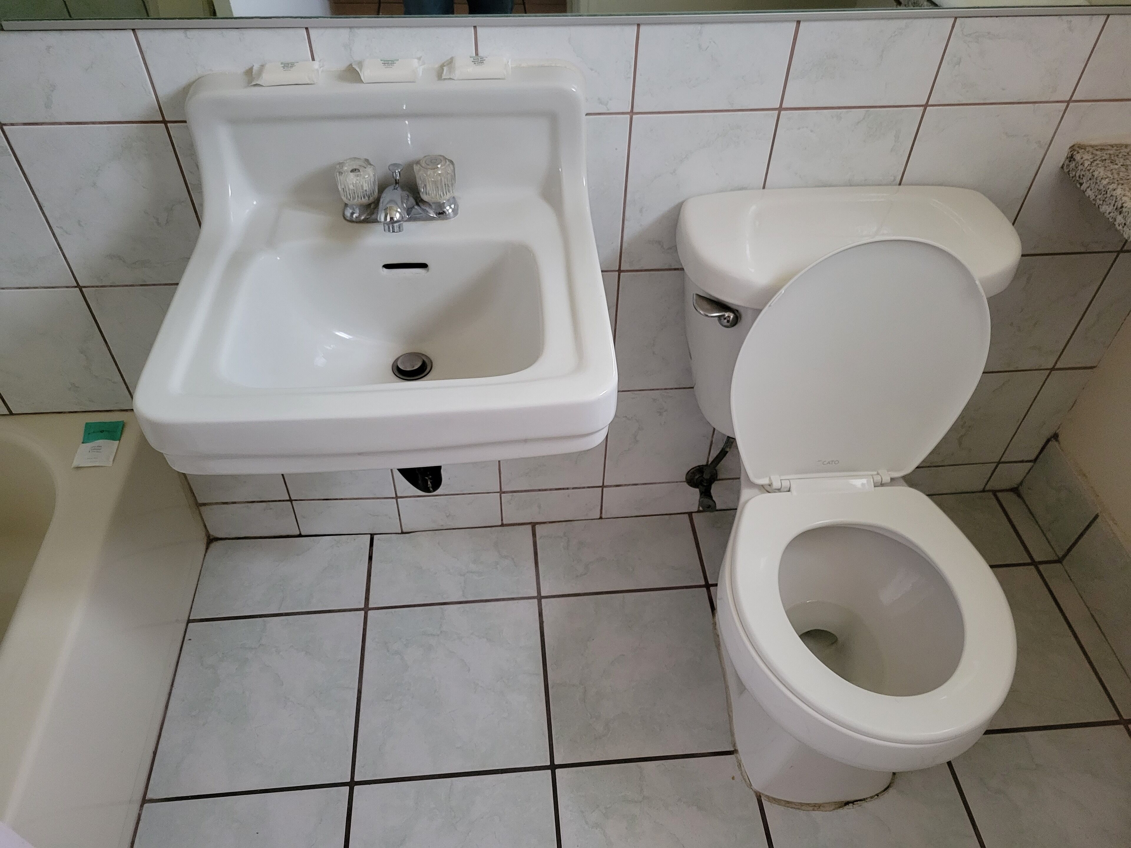 A bathroom with a sink, toilet, and bathtub.