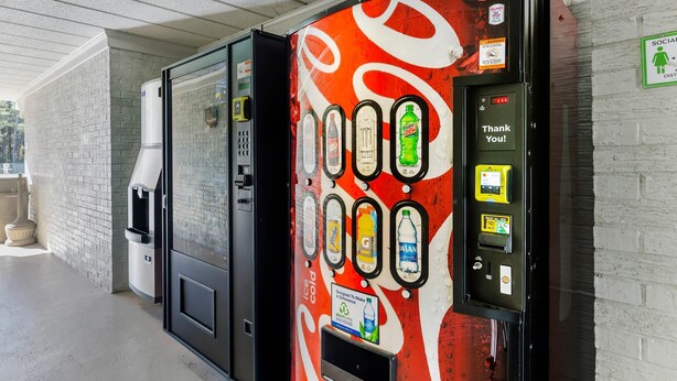 A vending machine with a Coca-Cola design, a water dispenser, and a "Thank You!" sign. - Quality Inn & Suites Easley - Greenville (Easley)