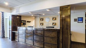 A reception desk with a wooden design and a sign that reads "Comfort Inn." - Comfort Inn Randolph - Boston (Randolph)
