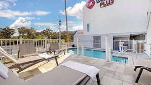 A hotel pool area with lounge chairs and a sign reading "Best Western PLUS". - Best Western Plus Marina Shores Hotel (Dana Point)