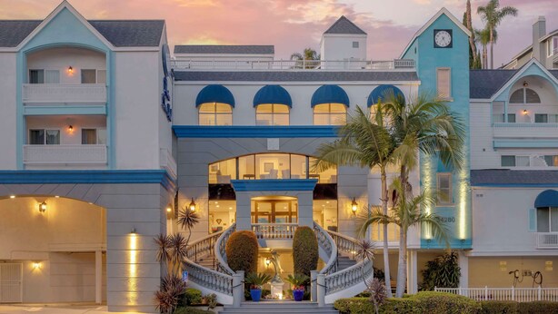 A hotel with a grand entrance, multiple balconies, and a staircase leading to the main entrance. - Best Western Plus Marina Shores Hotel (Dana Point)