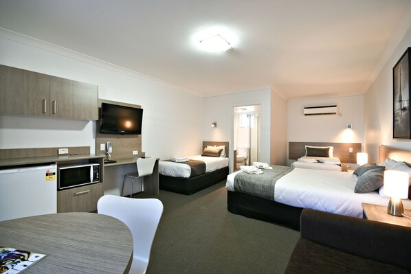 Family Room | Premium bedding, desk, blackout drapes, iron/ironing board