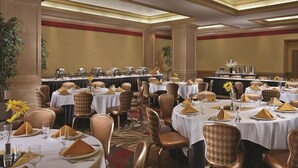 A banquet hall with round tables, chairs, and a long table with a buffet. - Circus Circus Hotel, Casino & Theme Park (Las Vegas)
