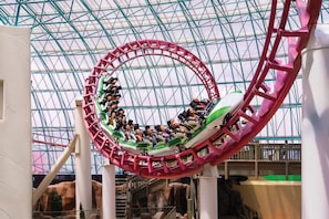 A roller coaster in a glass-roofed indoor amusement park. - Circus Circus Hotel, Casino & Theme Park (Las Vegas)