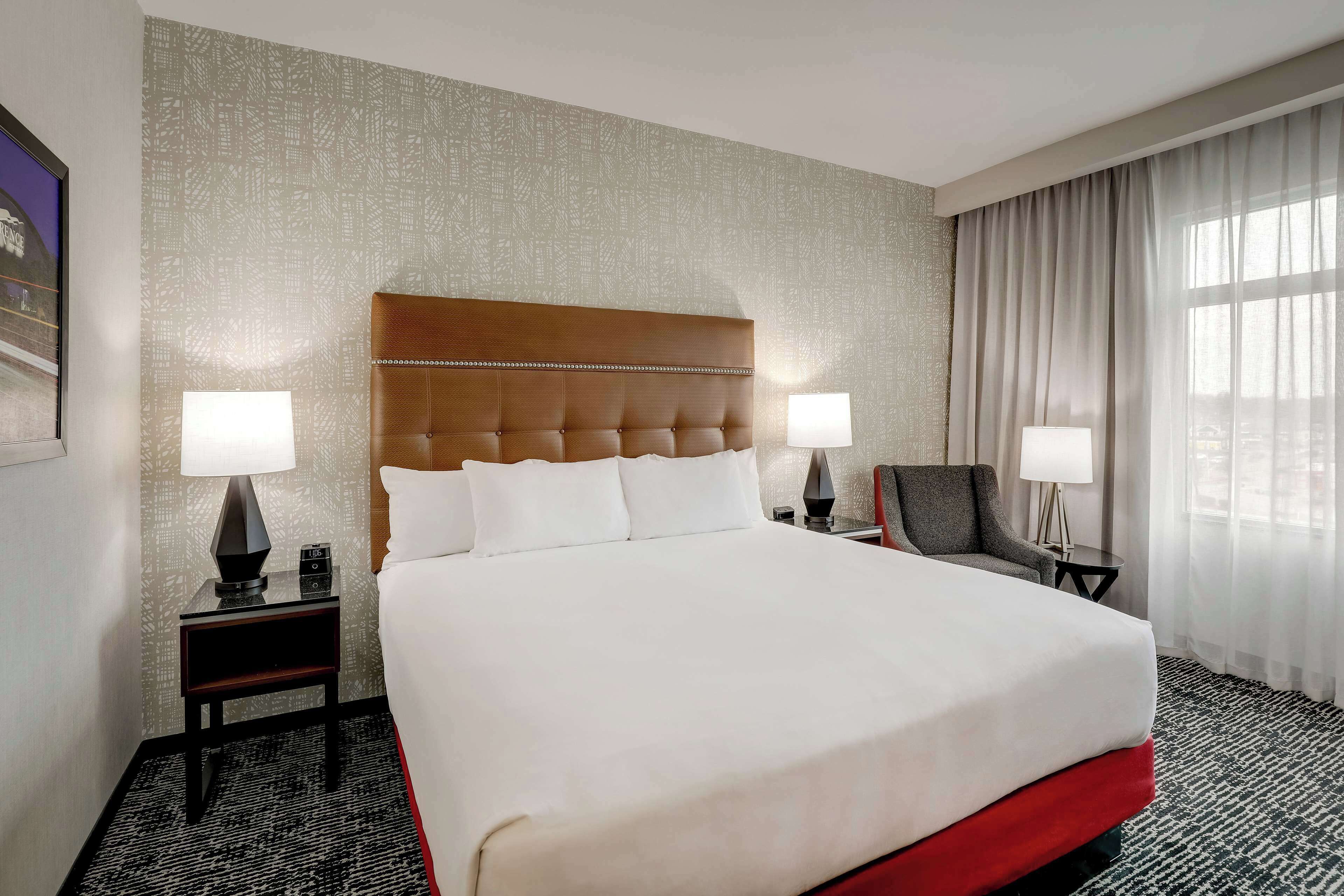 Premium bedding, desk, laptop workspace, blackout drapes