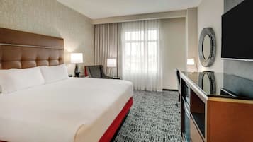 Premium bedding, desk, laptop workspace, blackout drapes