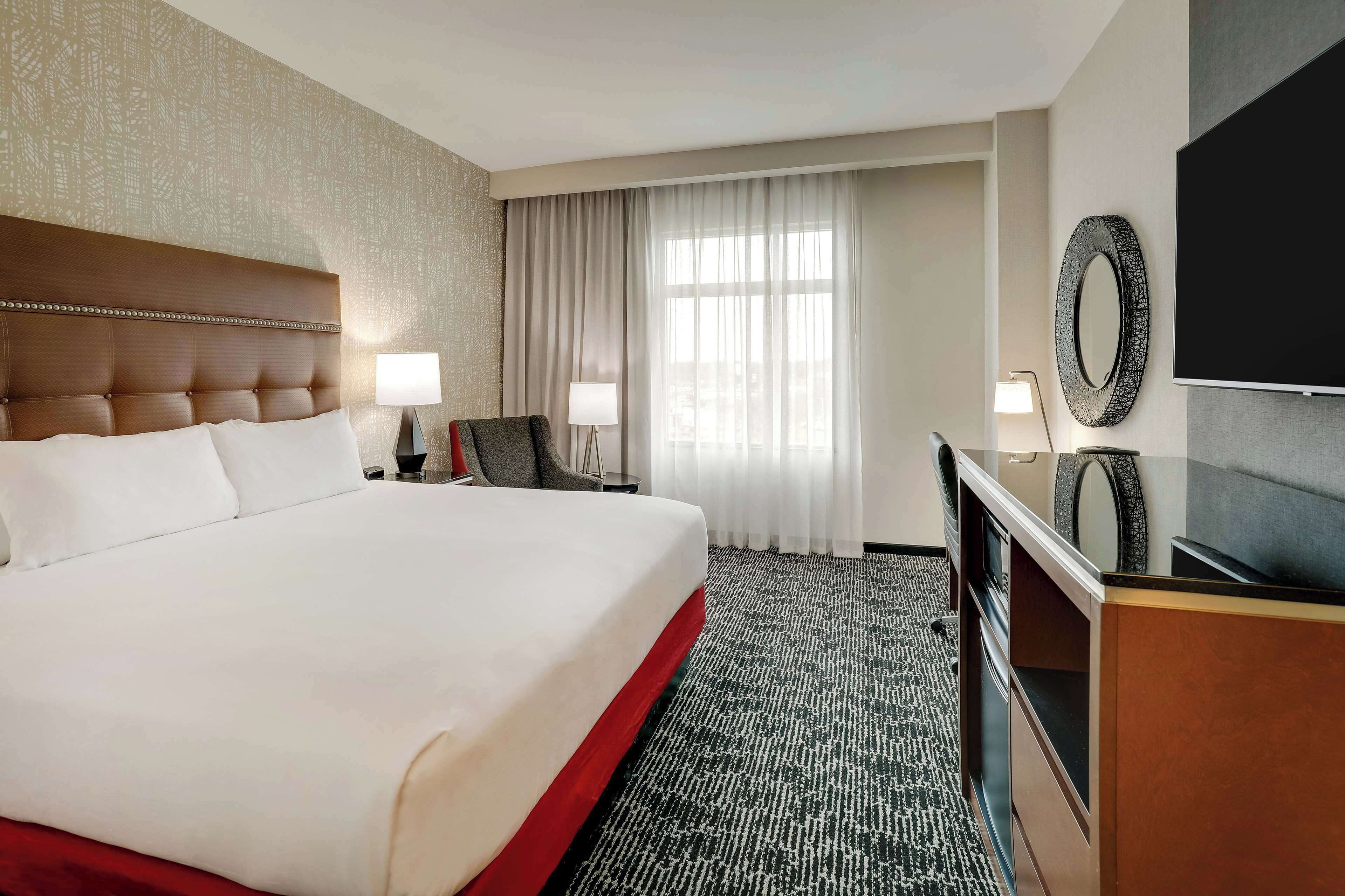 Premium bedding, desk, laptop workspace, blackout drapes