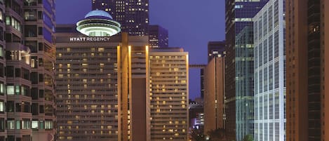 A high-rise hotel with multiple floors, a prominent dome structure, and a modern glass facade.