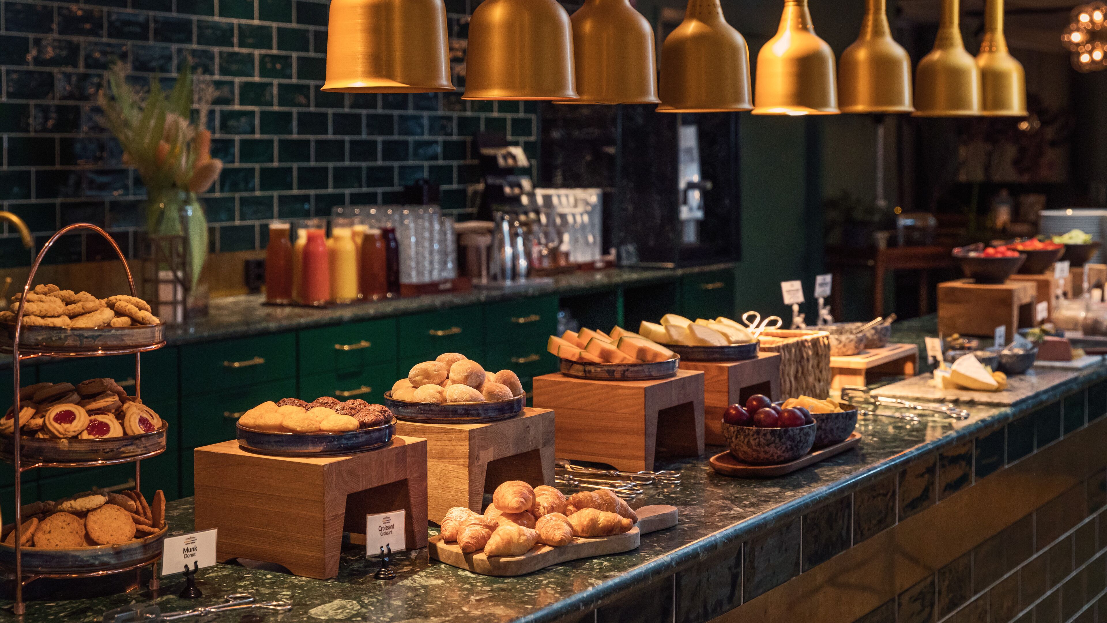 A buffet with various baked goods and pastries.