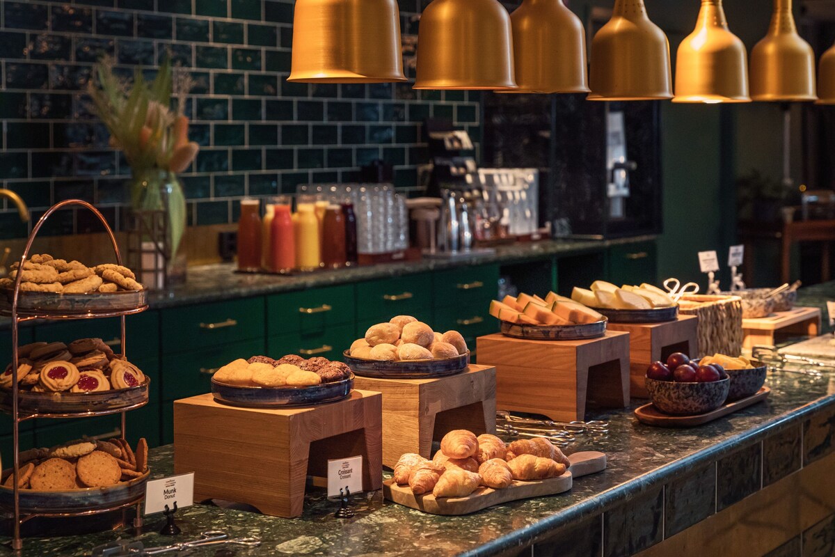 A buffet with various baked goods and pastries.