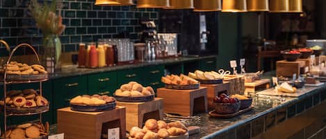 A buffet with various baked goods and pastries.