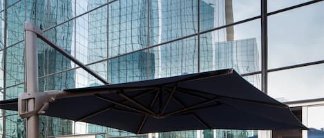 An outdoor seating area with a view of a modern glass building.