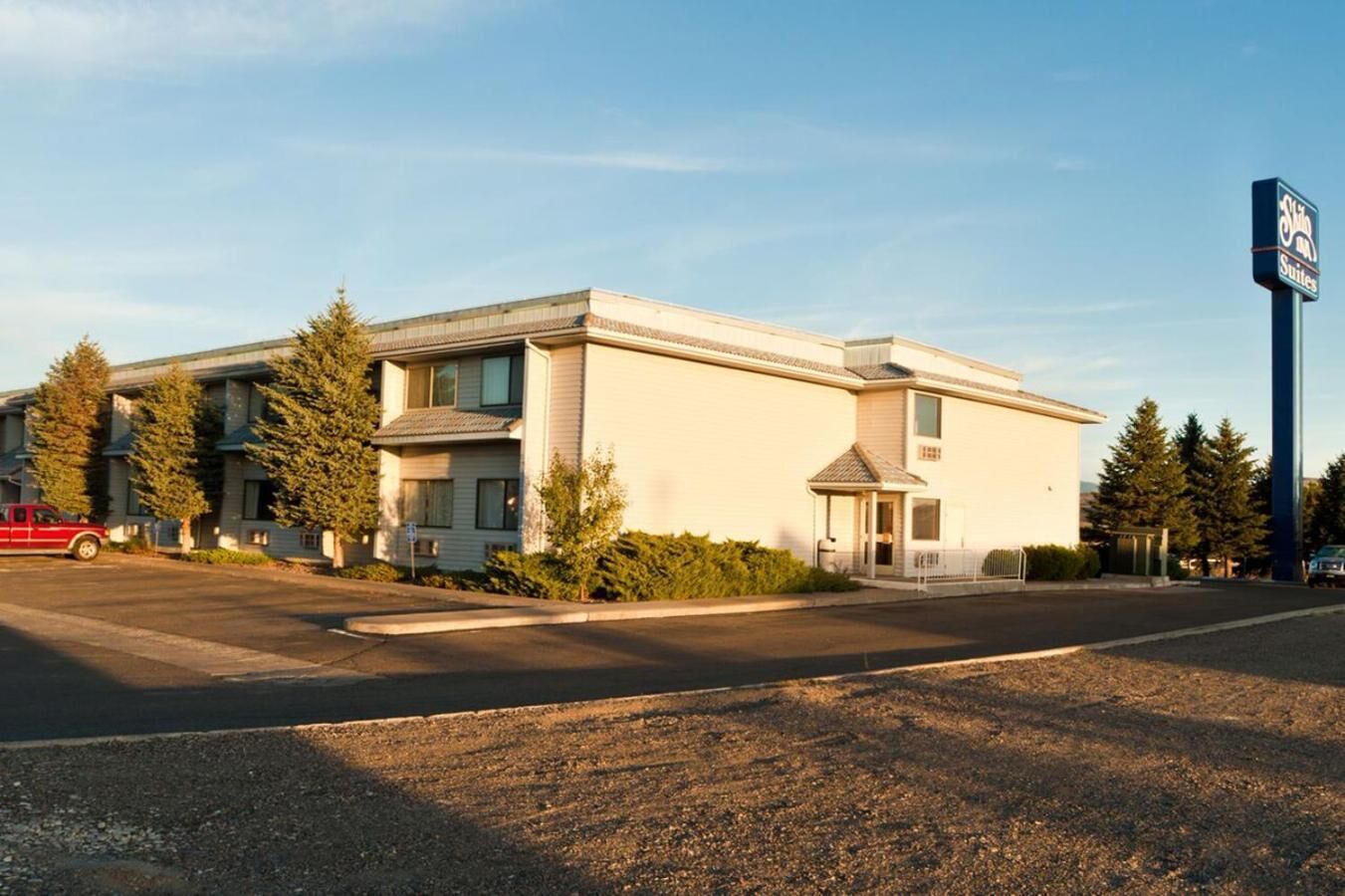 A two-story motel with a central entrance and a small porch.